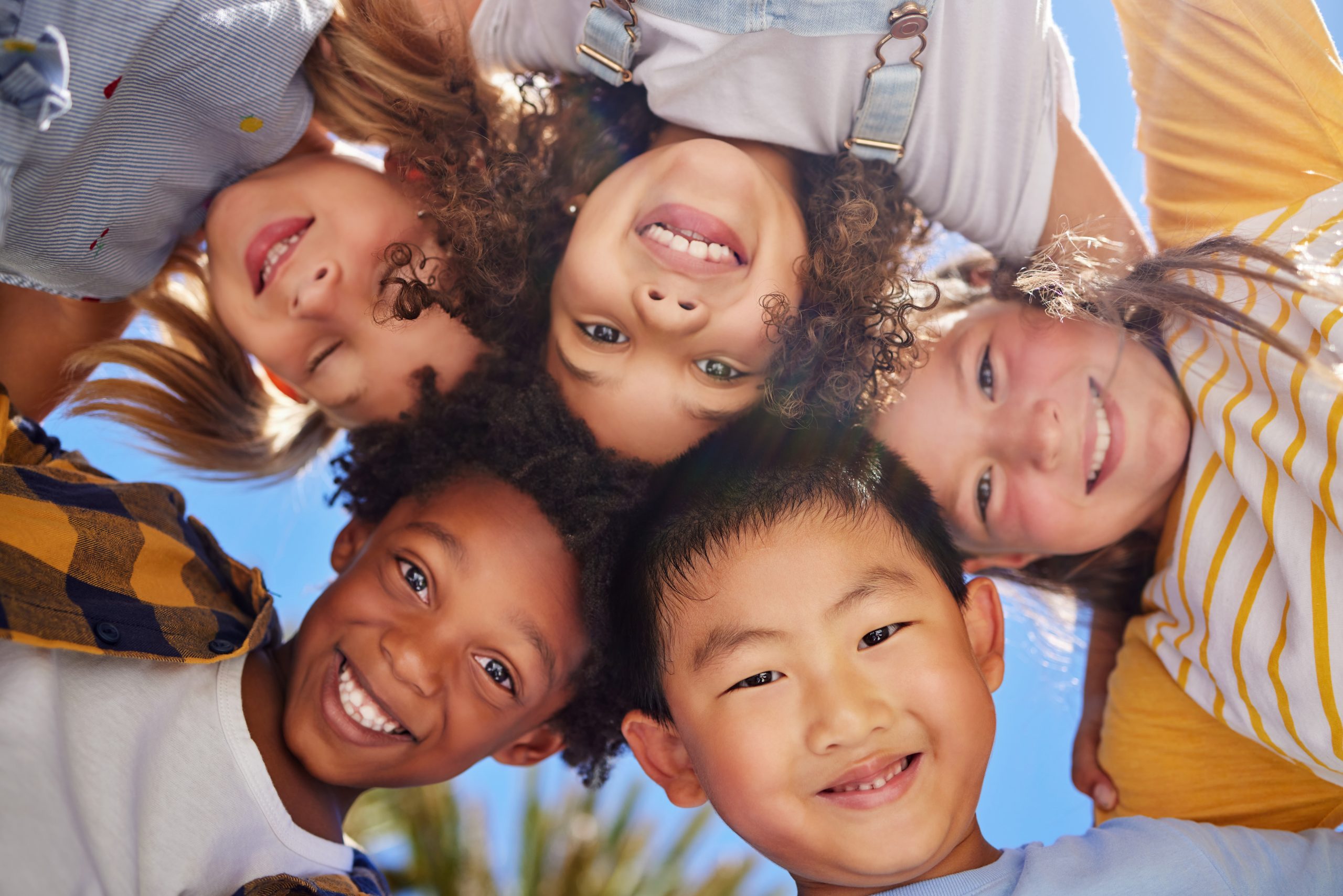 Did someone say summer camp. Shot of a group of kids standing in a circle in nature at summer camp