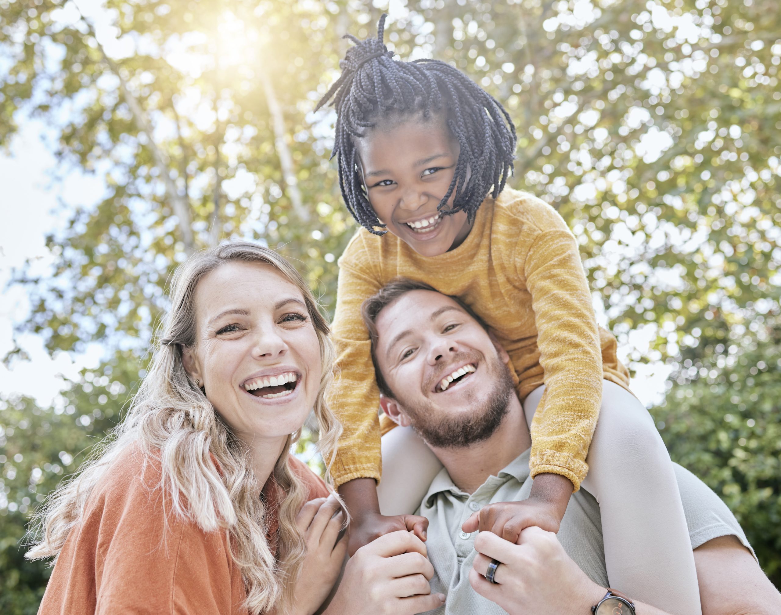 Diversity, adoption and girl with parents in a park in summer for support, love and care on holiday.